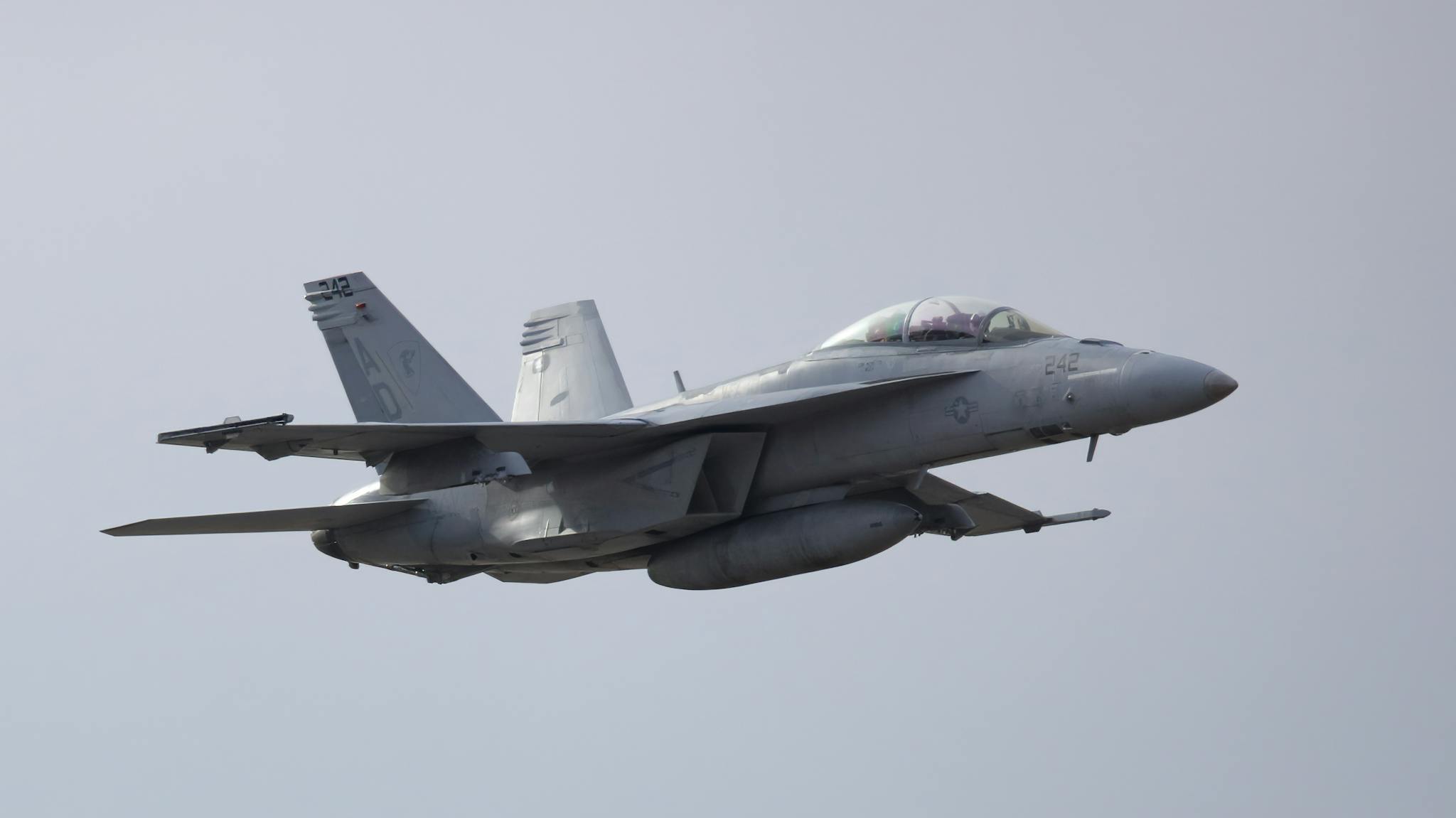 Close-up of a fighter jet in mid-air, showcasing aviation technology and design.