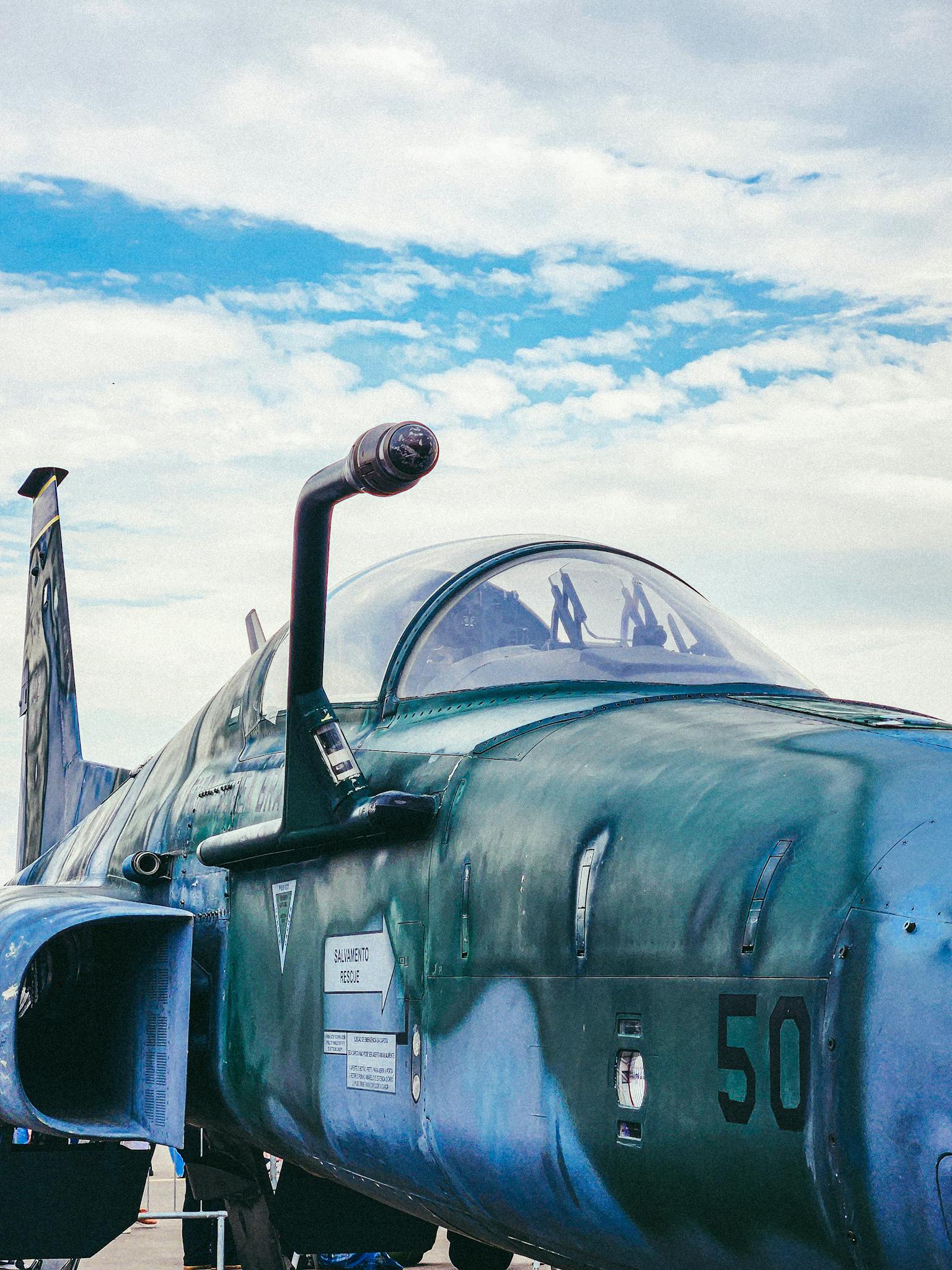 Close-up of a military jet aircraft against a vivid blue sky in São Paulo, Brazil.